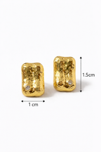 Gold earrings with measurements on a white background